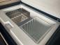 Preview: Mercedes Marco Polo Kühlschrank mit installiertem glänzenden Edelstahlregal, gefüllt mit Lebensmitteln und Getränken.